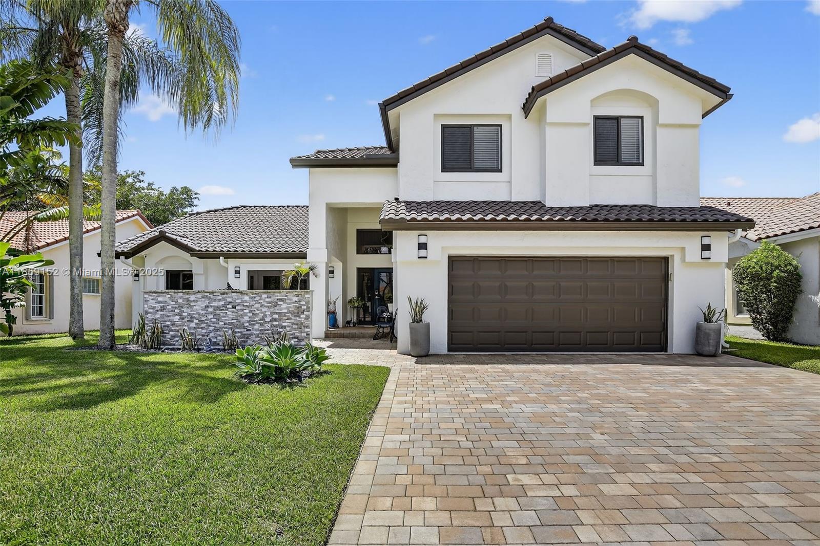 This stunning, fully renovated Estancia model waterfront home blends modern elegance with tranquil living in one of Weston’s most exclusive boutique gated communities. Featuring 4 bedrooms, 3 bathrooms, and an expansive open layout with soaring ceilings and walls of impact glass, every room is bathed in natural light and water views. The gourmet kitchen boasts a custom backsplash, quartz countertops, high-end stainless appliances, and abundant storage. The first-floor primary suite offers a spa-inspired retreat with soaking tub and walk-in waterfall shower. Outdoors, enjoy a Zen-style oasis with lush landscaping, a designer grilling area, and serene waterfront backdrop — perfect for both relaxation and entertaining. Luxury, tranquility, and exclusivity — all in one exceptional address.