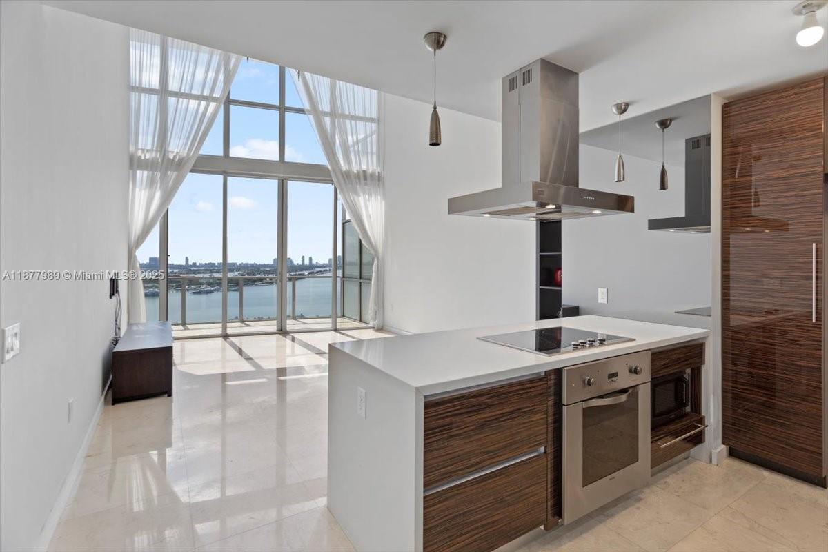 This beautiful residence offers 2 bedrooms (1 full + 1 converted den) and 2 full bathrooms. The den on the first floor has been thoughtfully converted into a cozy second bedroom, while the spacious closet on the second floor was transformed into a versatile guest room or home office. Enjoy an open floor plan with breathtaking views of Biscayne Bay, plus the convenience of in-unit laundry and a large storage closet. Building Amenities include: Two resort-style pools, State-of-the-art fitness center & yoga room, Spa & sauna, Playroom, 24-hour security, 1 assigned covered parking space + complimentary valet. This unit combines modern comfort, luxury amenities, and unmatched bayfront views.