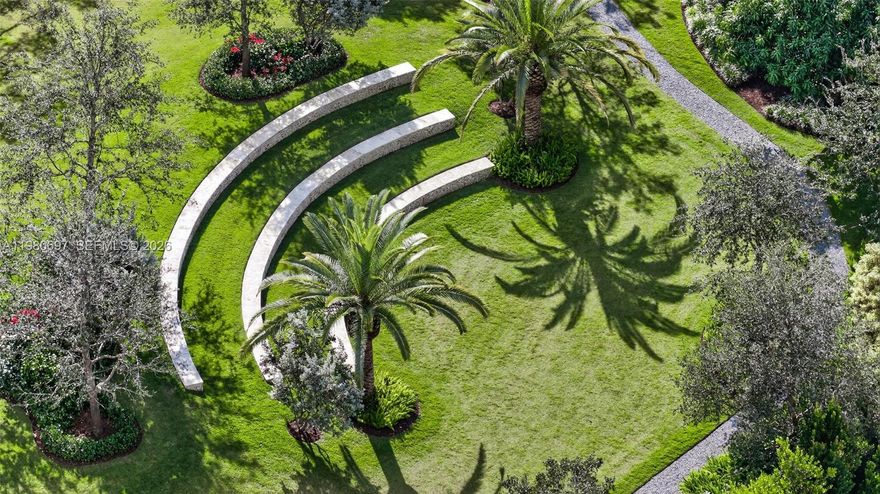 Tucked away on a quiet Pinecrest street, this exceptional estate offers rare scale, privacy and resort-style living on an expansive 1.78-acre setting. Front and back entrance driveways open to a grand oasis built for elegant entertainment and spa-like comfort.

Beyond the newly-renovated, heated pool and spa, is a multi-million dollar landscaping masterpiece featuring over 30 oak trees, exotic mangoes, gorgeous flora and plush zoysia grass. Stone paths journey around a rolling hill to a romantic fire pit illuminated by landscape lighting that lead to the property’s crown jewel… a Greek-style, outdoor theatre that must be seen to believe!
 
Inside, soaring ceilings and a private elevator compliment the home's 6 bedrooms, 5 full baths, 1 half bath, a dedicated office, two laundry rooms and a vast primary suite that features a private sitting area overlooking the vista in absolute privacy.
 
The chef's kitchen is equipped with premium appliances: Sub-Zero, Wolf, Viking and Bosch. The air-conditioned, extra-deep, 3-car garage with appliances serves as an optional gym/entertainment space. Hurricane-impact windows and doors and commercial-grade garage doors, ensure security against the elements. A discrete and integrated front entry ramp provides accessibility.
 
Live near Pinecrest's world-class public and private schools, Deering Bay Yacht & Country Club's golf and tennis lifestyle, Fairchild Tropical Botanic Garden, Deering Estate and Pinecrest Gardens.