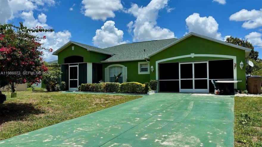 Welcome to this charming split-plan residence in Lehigh Acres, offering 3 bedrooms, 2 bathrooms, and a 2-car garage. Thoughtfully designed, the home features tile flooring throughout and a spacious primary suite complete with a sitting area, soaking tub, separate shower, and a large walk-in closet.

Enjoy multiple living spaces, including a generous family room, a formal living room, and an eat-in kitchen accented with granite countertops. The expansive backyard is a true gardener’s paradise, filled with an impressive variety of fruit trees and plants such as mango, pineapple, ackee, guava, plums, naseberry, sugar cane, avocado, sweet potato, pumpkin, and peppers, along with a beautiful shade tree for added comfort.

Additional highlights include a large linen closet, a brand-new roof, a 2-year-old A/C system, and a new water heater. This well-maintained home offers both comfort and character—definitely one worth seeing in person.