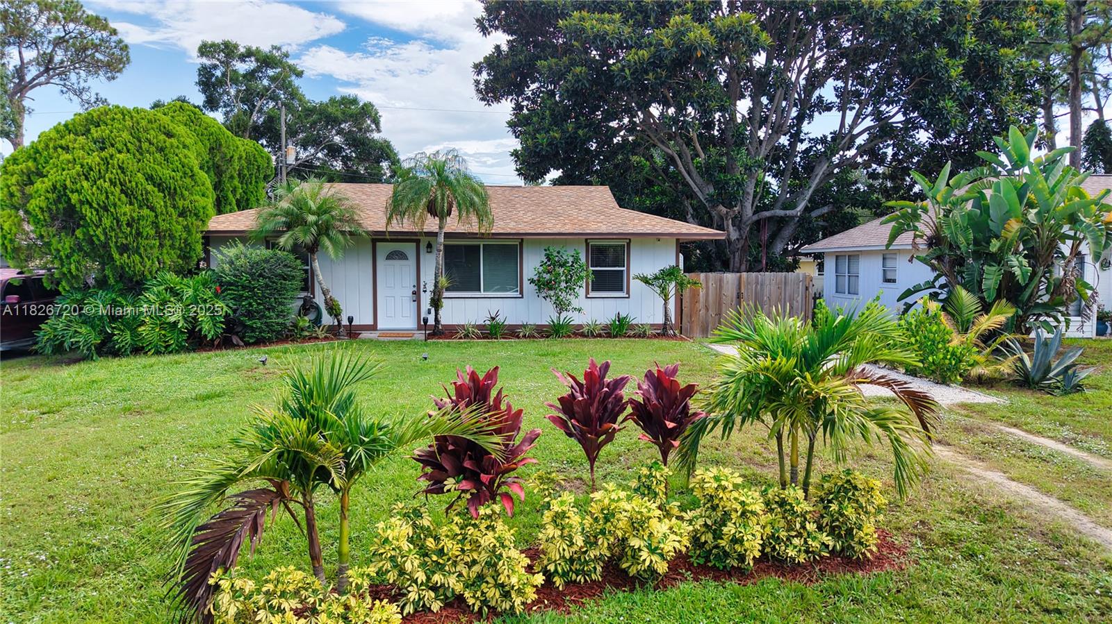 Welcome to this beautifully maintained 2/2 home with a split floor plan. New roof installed in 2021 & brand-new windows added in 2025. Step outside to a screened patio & fully fenced backyard, perfect for pets, gardening, or outdoor entertaining. 2 powered storage sheds offer ample space for tools, hobbies, or a workshop. Irrigation well is ready if you want to install sprinklers. Located in a convenient central location. No HOA means more freedom and fewer restrictions. Fresh & clean, it's ready for its new owners. Don’t miss out on this charming home – at this price it won’t last long!