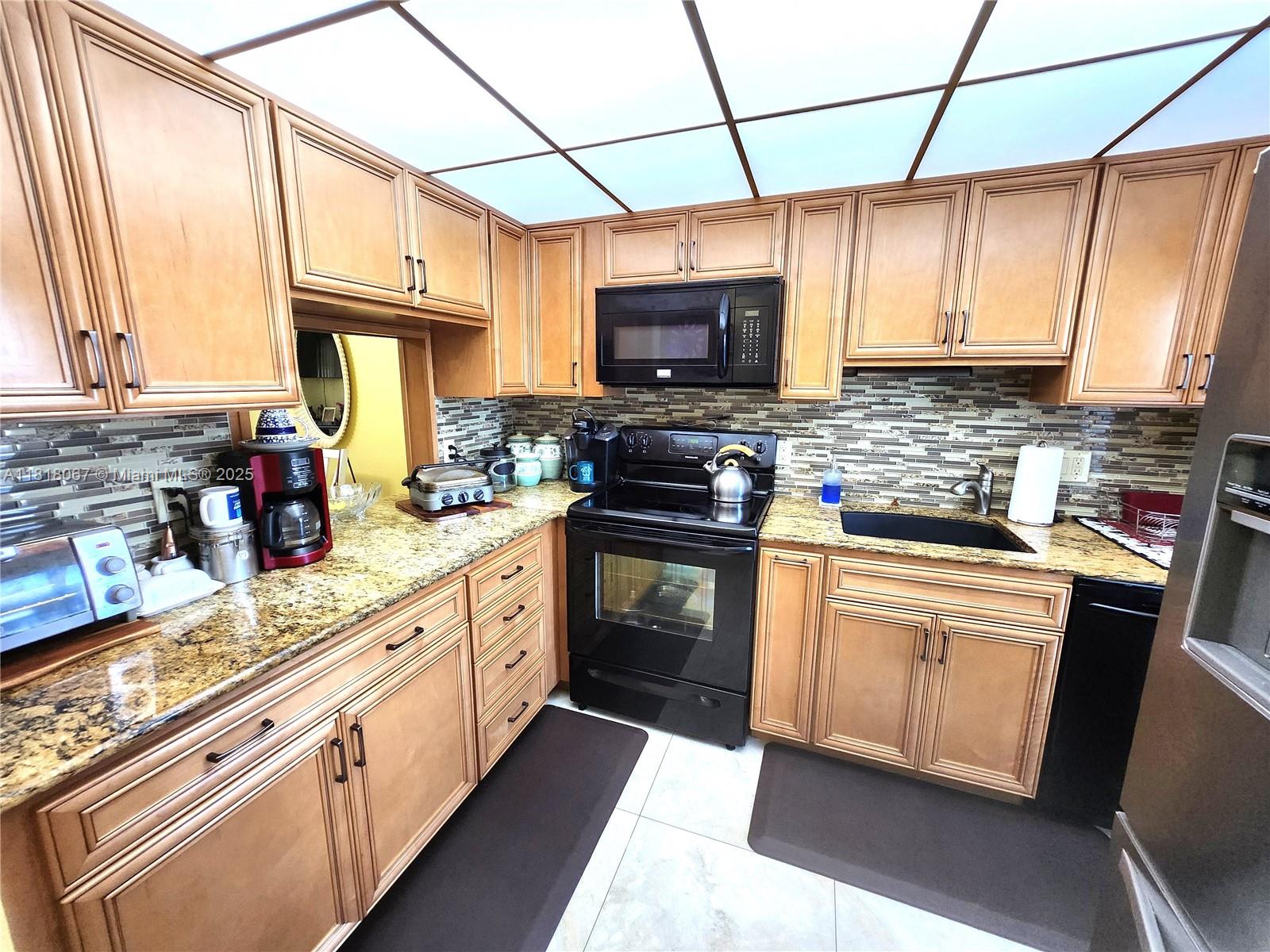 Welcome to this beautifully maintained 2-bedroom, 2-bathroom ground floor, corner unit, perfectly situated for easy access. Steps away from the pool & clubhouse, this home offers the ideal blend of comfort & community. Unit has impact windows throughout. The kitchen features stainless steel appliances & flows seamlessly into the open living area, all adorned with tile flooring throughout for a clean and modern feel. The spacious primary bedroom boasts a walk-in closet, providing ample storage. Enjoy your days surrounded by serene greenery, take a refreshing dip in the inviting pool, unwind with a good book in the community library, or challenge a friend to a friendly game of shuffleboard or golf putting. This is more than just a home, it’s a lifestyle. Schedule your private showing today!