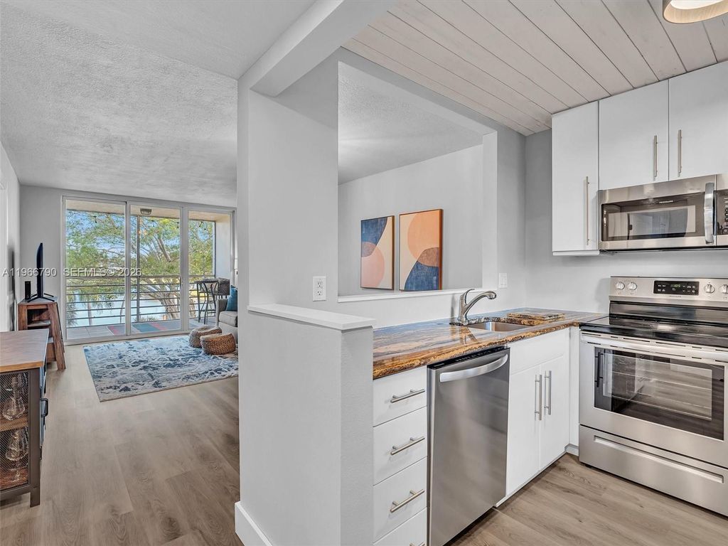 Photo of 9340 Lagoon Pl #303, Davie, FL 33324 (MLS # A11966790)