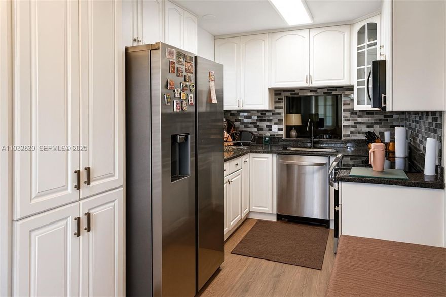 Beautifully remodeled 2 bedroom 2 bathroom first floor corner unit in the desirable 55+ Bermuda Club community! This rare unit offers a larger floor plan than standard models in the building featuring an extended living area a breakfast nook and a separate dining space. Enjoy stunning lakefront views from the main living areas with extra windows providing an abundance of natural light. The spacious layout includes two large bedrooms each with walk in closets and updated bathrooms. The kitchen and living areas have been tastefully upgraded with modern finishes. Corner unit location adds privacy convenience and extra square footage. Located in a quiet well maintained community with resort style amenities this move in ready condo is truly one of a kind.