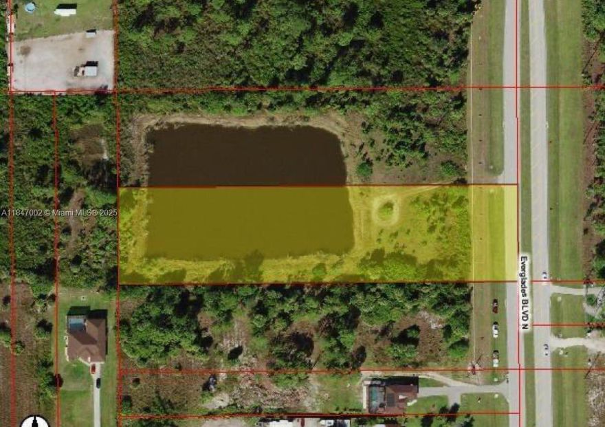 Prime 2.58 acre residential lot in booming Naples area with 197 ft of paved frontage. Surrounded by native palms,  Full municipal utilities water, sewer, and electricity are available. Enjoy waterfront access to lake. Zoned for residential use, perfect for a luxury home or private estate near top rated schools, airport, and local amenities.
