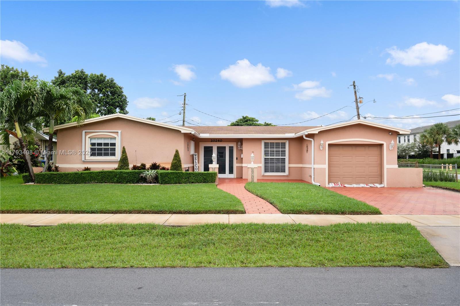 This completely remodeled 3-bedroom, 2-bath home is situated on a desirable corner lot in a prime residential neighborhood. The home features a new kitchen with quartz countertops and new appliances, providing a modern and stylish space for cooking and entertaining. Enjoy the cozy living room and spacious family room, perfect for gatherings or quiet relaxation. The home also boasts luxury vinyl flooring throughout, a beautifully landscaped yard, a spacious screened-in patio for outdoor enjoyment, a 1-car garage, and a large shed for extra storage. Located within a secure gated community with a guard booth at the entrance and is close to Hard Rock Stadium and major throughfares making it easy to commute to your favorite places in Miami-Dade and Broward counties.