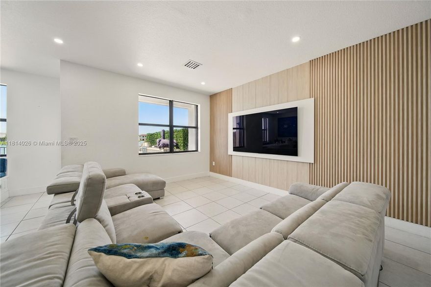 Discover this immaculate waterfront townhome featuring 3 spacious bedrooms and 2.5 bathrooms. The entrance foyer and spacious living room are adorned with beautiful acoustic wood panels, creating a warm and inviting ambiance. The open-concept layout flows seamlessly into the kitchen, complete with an eat-in counter and sleek stainless steel appliances.The large, sunlit primary suite includes a soon-to-be newly renovated bathroom. Step outside to a fenced patio designed for entertaining, featuring an impressive outdoor kitchen with BBQ, elegant travertine flooring, and serene water views—perfect for relaxing.Enjoy resort-style amenities including a spectacular pool, gym, and clubhouse. Conveniently located just minutes from the highway, marina, and shopping plazas. A true gem!