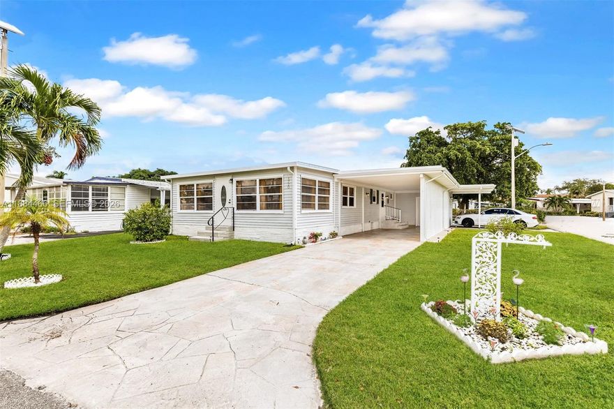 Step inside this spacious move-in ready 2bed/2bath double wide manufactured home in The Estates of Ft. Lauderdale, an ALL-AGES community where YOU OWN THE LAND! The corner lot location allows for abundant natural light to fill the living spaces. This home has been meticulously maintained by the homeowners, purchase with confidence, not headaches. Features brand new vinyl wood flooring throughout main living areas and bedrooms, New kitchen counter top, New stainless steel appliances, soft close drawers, pantry pullout shelves, refreshed bathrooms with new tiled showers, new plumbing, new lighting, freshly painted inside/out, roof resealed and painted, A/C + water heater 2021, stamped concrete driveway, new carport privacy lattice, large shed with freshly painted walls and epoxy speckled flooring, enclosed versatile Florida room in front that’s perfect for relaxing, entertaining, or working from home but what truly sets this home apart is the in-law suite with kitchenette and own entrance + parking space in back, perfect for extended family, guests or rental potential. LOW HOA - $115/month. Enjoy a vibrant community lifestyle with resort-style amenities - pool, gym, sauna, golf, bowling, shuffle board, pickleball, tennis, and a full social calendar. Conveniently located near the beach, shopping, iconic Hard Rock guitar hotel, dining, highways! This home offers comfort, flexibility, and Florida living at its best.