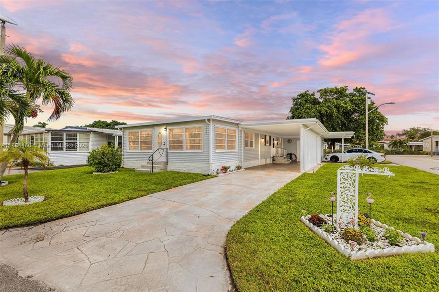 Step inside this spacious 2bed/2bath corner lot, double wide manufactured home in The Estates of Ft Lauderdale, an ALL-AGES community where YOU OWN THE LAND! Features kitchen SS Appliances, refreshed bathrooms w/retiled showers, new lighting, freshly painted inside/out, roof resealed, A/C + water heater 2021, long stamped concrete driveway, new carport privacy lattice, large shed, and enclosed versatile Florida room in front but what truly sets this home apart is the in-law suite with kitchenette and own entrance and parking space in back, perfect for extended family, guests or rental potential. LOW HOA - $115/month. Enjoy resort-style amenities - pool, gym, sauna, golf, bowling, pickleball, tennis, and a full social calendar. Close to beach, shopping, dining, highways & Hardrock casino!