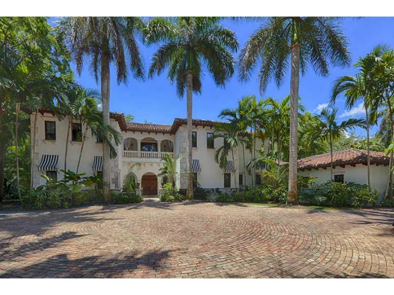 Entertainer's dream at this Peter Gallo designed NE Pinecrest tropical paradise. Situated on 1 acre w/ manicured lawn & lush foliage complimenting an inviting pool & enormous covered patio. The property features coral rock bathing grottos, koi ponds, tiki  huts, and hot tub. Home has many distinct architectural details & exudes a warm charm. Soaring ceilings, oversized master w/ office, 5 ensuite bedrooms, mrble & wd flrs, impct win/drs, Formal LR & DR, 2 FR, Chef's gourmet gas kit, 3 car garage, generator