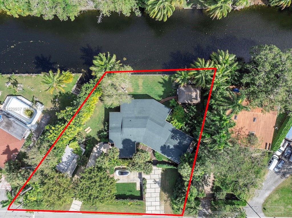 Nestled along a serene canal, this fully renovated home is a private tropical retreat where beauty, nature, and tranquility meet.Surrounded by thoughtfully designed gardens and vibrant colors, every room offers peaceful canal views and opens to the outdoors.With 3 spacious bedrooms (2 masters) and 3.5 bathrooms, the home features an open living and dining area, and a designer kitchen with elegant wallpaper and high-end finishes.A detached art studio adds creative space, while outdoor living is elevated with a large covered porch and a spacious tiki with an outdoor bar right on the water.The property is fully fenced, with ample parking and two gated entrances one electric and one manual for added privacy and ease.Just steps from Miami Country Day School,yet tucked into its own quiet oasis.