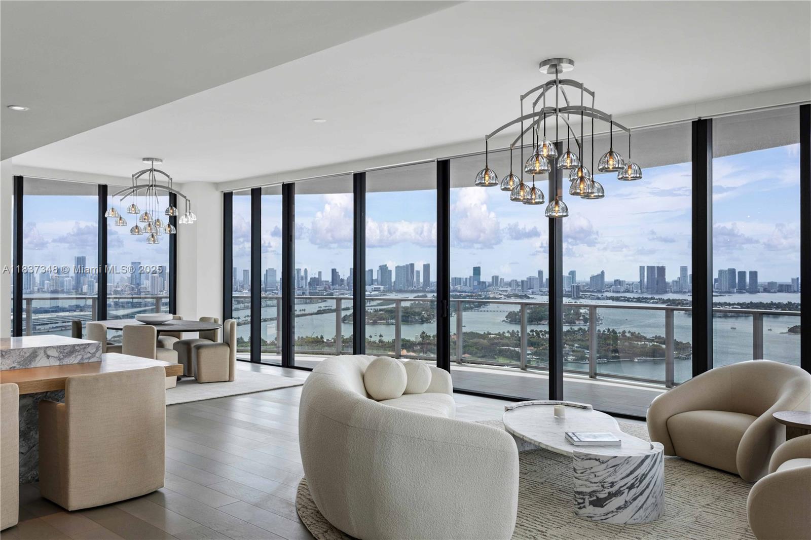 This exceptional residence at Five Park offers unobstructed, panoramic views that span ocean to skyline—making every moment, morning or night, nothing short of spectacular. Completely surrounded by a wraparound terrace and floor to ceiling glass, this brand new turnkey residence is available immediately. Having opened in 2024, this cutting-edge development offers an extensive list of amenities, from a private club, spa, cinema, playrooms, workspaces, café, pools, and access to a beach club with full services. The attentive staff ensures all of your needs are comfortably addressed. 2 parking spaces included.