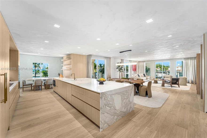 Completely and expertly renovated 2,744-SF residence with 3BR and 3.5BA overlooking Fisher Island’s inner marina. Features five terraces, a gated front entry, three side terraces with Biscayne Bay and Miami skyline views, and a marina-facing terrace. Interiors by Sensi Casa Design Studio create a cohesive turnkey home with a pivot entry door, wide-plank oak floors, Italian oak doors, limewashed walls and ceilings, and custom Pedini closets. The open living and dining areas include bespoke millwork, a bar, and terrace access. The Del Curto Italian kitchen offers a marble island, Wolf, Miele, and Sub-Zero appliances, plus a breakfast area. The primary suite has terrace access, a walk-in closet, and a spa bath. Two additional ensuite bedrooms also offer custom closets and terrace access.