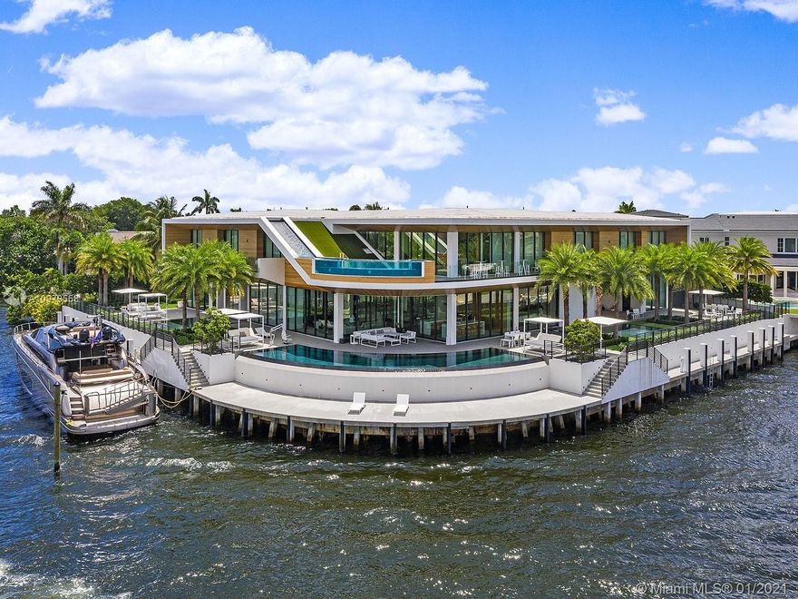 A fresh departure from expected Boca Raton luxury, this spectacular contemporary residence on an oversized Intracoastal Waterway lot offers 343 feet of water frontage and 270-degree views. Incorporating extraordinary amenities such as four pools, extensive private dockage, an upstairs bar, a green roof, atrium-like interiors, formal and catering kitchens, and a waterfall descending from the roof, this estate offers privacy and over-the-top luxury at a breathtaking scale. Soaring walls of glass open the living spaces to vast vistas, while each of the 9 bedrooms, including the dedicated master wing, opens directly to outdoor space. The truly showstopping moment, however, is watching the waterway to the west, buzzing with yachts, through the glass-walled plunge pool, and spotting the sunset.