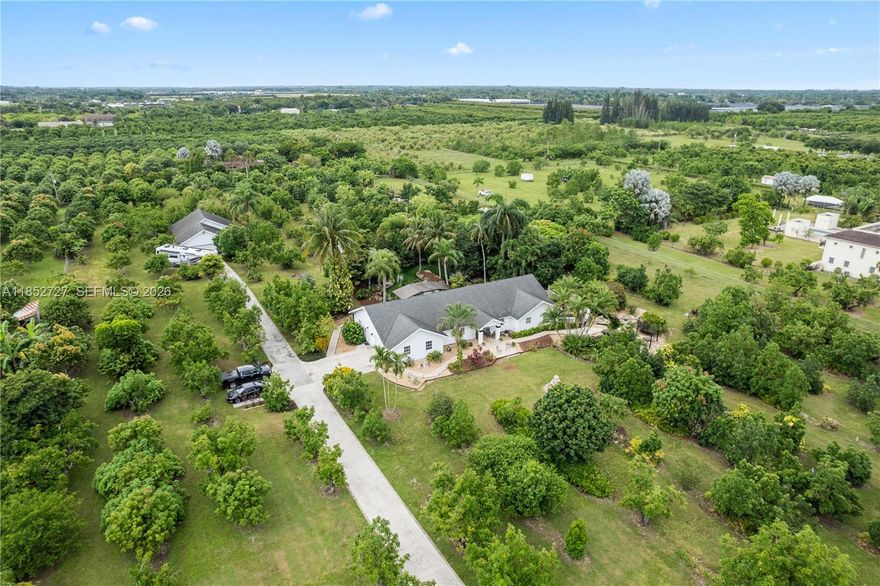 Tropical paradise in the heart of the Redlands. This rare 5-acre agricultural estate offers two homes, lush grounds, and tranquil water features that create a true private retreat. The main residence features 3 bedrooms, 2.5 baths, a 2-car garage, with updated kitchen and bathrooms.  A separate 2-bedroom, 2-bath guest home with its own 2-car garage is ideal for multigenerational living or rental income. Meandering ponds set the tone for relaxation, including an oversized koi pond easily convertible to a swimming pool, all enjoyed from a shaded gazebo and tiki bar. The property is enriched with a variety of fruit trees and fully fenced for privacy. Additional features include RV parking with 50-amp hookup, barn, sheds, and chicken coop. A unique opportunity to own a serene tropical oasis with space, versatility, and income potential.