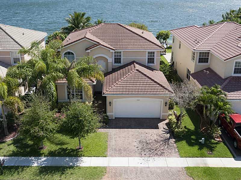 Stunning 5 BR, 3 bath waterfront home in manned gated Sunset Falls. Upgraded throughout, gourmet kitchen w/ top cabinetry, granite counters, stainless steel appliances Gorgeous big lake views from home, patio, yard. Super master suite, tray ceilings, walk -in closets, Roman tub, his & her vanities. Wrought iron/wood bannister, French doors, covered patio, pergola. 1 BR suite downstairs. Resort level community amenities including lakeside pool, clubhouse, fitness center, tennis. Sunset Lakes Elementary.