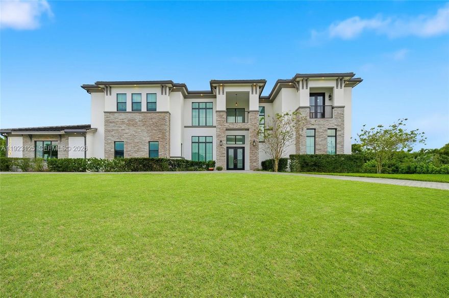 Introducing the Best-Priced 2022+ Newer-Construction Estate in all of Southwest Ranches offering 7-Bedrooms + an Office & 8.5 Bathrooms! A rare offering that blends exceptional value with true luxury and total privacy. Set on just over an Acre of meticulously manicured grounds in the exclusive Magnolia Estates enclave, this impressive estate delivers grandeur at every turn. Soaring ceilings, Walls of Glass, and Sun-filled living spaces create a Bright, Elegant atmosphere with a seamless indoor/outdoor flow. Each bedroom is a private retreat with its own En-Suite Bath and fully built-out Custom Walk-in closet. The Chef’s Kitchen commands attention with a Massive Entertaining Island, bespoke cabinetry, and Top-tier JennAir appliances, connecting effortlessly to the family room, formal living room, expansive dining area, and sleek Wet Bar. Step outside to a lush Resort-caliber Oasis featuring a covered patio with electronic screens, a Full Summer Kitchen with Californo Pizza Oven, Grill, Wine fridge, and a sink, plus a sparkling Saltwater Pool, Outdoor fireplace, and fenced private grounds. Additional Luxuries include an Elevator, Smart-home automation, and a 3-car garage with EV charging. With Top Schools, Parks, and Major Highways moments away, this Extraordinary Residence is the Epitome of Modern Southwest Ranches living.