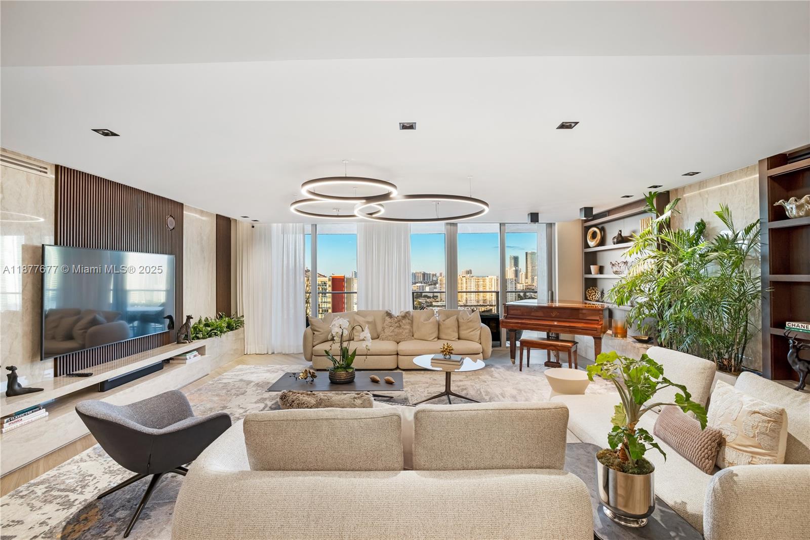 This stunning residence at 330 Sunny Isles Blvd Apt 5-2403 offers unmatched elegance with over $600K in designer upgrades. Featuring custom Italian Mia Cucina doors, Florense closets, panels, and built-ins throughout, the home is both functional and luxurious. The kitchen showcases a unique wood countertop finish, while a refined lighting design with chandeliers and recessed fixtures transforms the ambiance. The master suite was expanded and finished with full marble in the bathroom, custom closets, and a dramatic floor-to-ceiling fabric panel. Additional highlights include automated lighting, AC, curtains, a glass-enclosed family room, linear AC vents, electric blackout and sheer shades, a guest room with a fold-away bed. Every detail has been thoughtfully curated, to a one of a kind apt