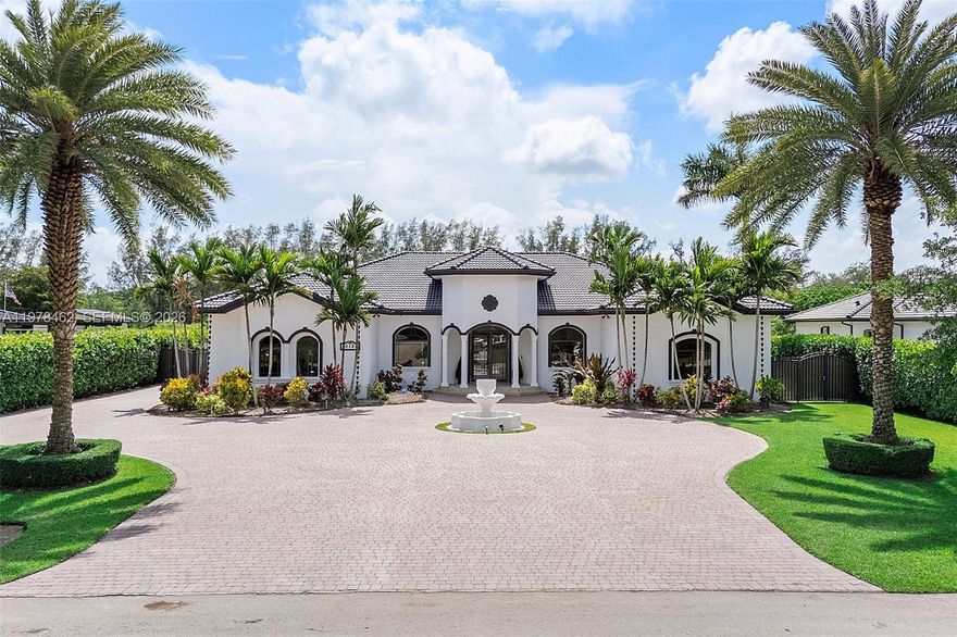 Nestled in SW Miami, sitting on one of the largest lots available with over 34,000 sq. ft., this stunning 4-bed, 3.5 bath, 3-car garage custom home boasts an expansive layout with 4083 sq. ft. of living space. A few of the many features include soaring high ceilings that create an airy and inviting atmosphere, a gourmet kitchen with top-of-the-line appliances (Sub-Zero fridge), marble flooring, custom LED lighting, crown molding, and high-impact windows & doors. Along with a freshly painted exterior, a whole-home water filtration system, a whole-home central vacuum, and a custom indoor/outdoor sound system. Outside, discover a serene oasis with a sparkling 20' x 40' pool and jacuzzi, surrounded by lush landscaping that enhances the tranquility of the property along with avocado and mango trees, and a built-in generator & BBQ grill kitchen complete with a 200-gal propane tank.