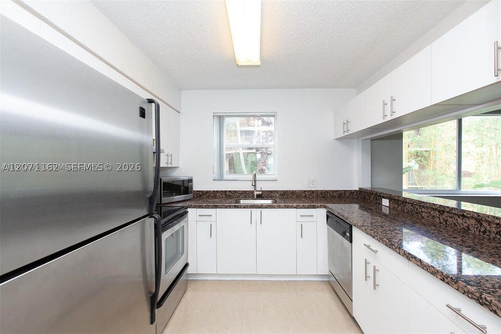 Photo of 771 N Pine Island Rd #214, Plantation, FL 33324 (MLS # A12071162)