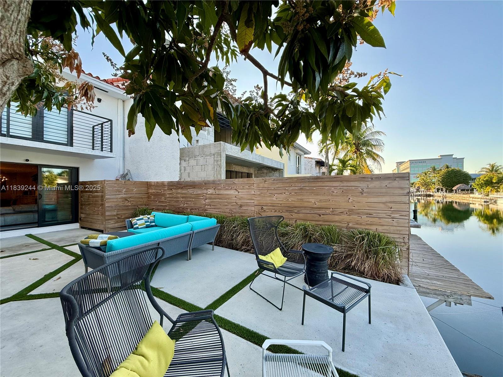 NO HOA Waterfront Luxury in Prime Location! Fully renovated 2-bed, 2.5-bath townhome is a boater’s dream with direct ocean access and private deeded dock. Just minutes to Bal Harbour, beaches, and top dining, this home offers unmatched convenience. Features include SIW impact windows/doors, Porcelanosa floors, motorized blinds, and custom cabinetry with Dekton countertops. The Miralis kitchen is equipped with Miele fridge/freezer/dishwasher, Bosch oven and cooktop, and a sleek Falmec hood. Spa-style baths offer frameless rain showers, heated LED mirrors, and Toto washlet toilets. With new plumbing, electrical, and HVAC, it's fully move-in ready. No HOA or maintenance fees – the ideal mix of water access, location, and modern luxury!