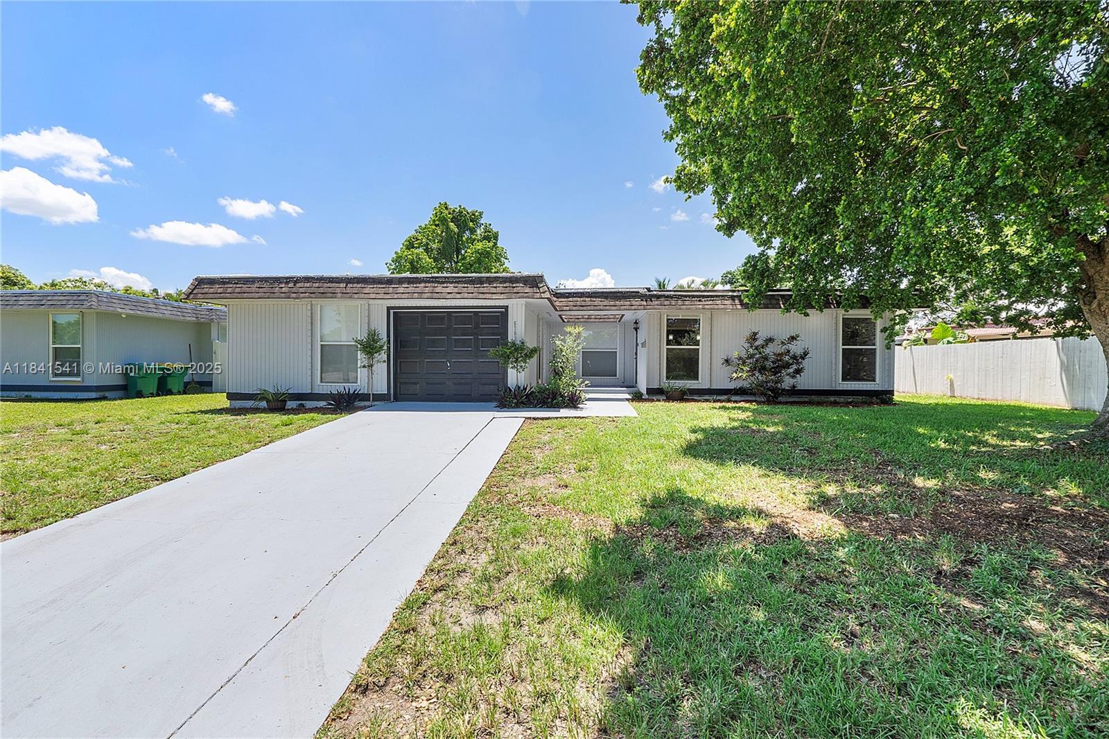 Wow! Beautifully Updated All Ages 3 Bed / 2 Bath Single Family Home Located In The Heart Of Tamarac On An Oversized Lot. This Home Features A Large Open Layout With Lots Of Natural Light. New Flooring. Accent Stone Wall. Recessed Lighting. Newer Kitchen W/ Lots Of Cabinets, SS Appliances, Pendant Lights & Breakfast Bar W/Seating. Large Florida Room Has A Ceiling Fan And Wood Plank Ceiling. Large Primary Suite W/ Ceiling Fan & Walk-In Closet With An En-Suite Bath That Has An Updated Shower And Vanity. 2nd Bedroom Has A Fan & Walk-In Closet. 3rd Bedroom Is A partially Converted Garage With Window And Closet. Laundry Room With Full Size Washer/ Dryer. Updated Hall Bath W/ Newer Tub/Shower & Vanity. Close To Shopping, Restaurants & Highways. Don't Miss This Opportunity!