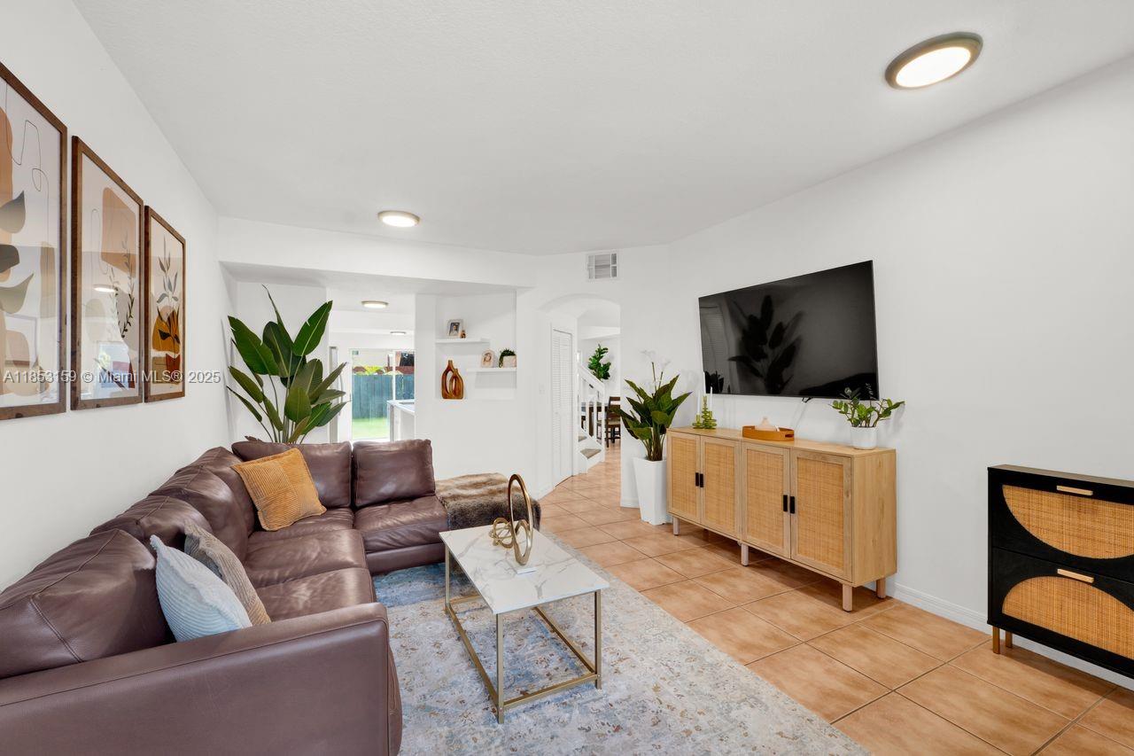 Welcome to rarely available Tiffany of Kendall, 3 bed, 3 bath, 1 car garage, parking for 2 additional cars. Living area leads to the kitchen & family room area with seamless access to the beautiful backyard, great for entertaining, play area for the kiddies or furry babies. Tile floors on the first floor & laminate wood on the second level. Primary bedroom has vaulted ceilings, a spacious walk-in closet, a large bathroom with double sink & walk-in-shower. The 2nd & 3rd bedrooms have wonderful lighting & built-in closets. Located near highways, hospitals, supermarkets, shopping & entertainment. Updates include, newer stainless-steel appliances, laminate flooring, AC system replacement, "Titan" on demand, water heater, freshly painted & bathroom renovations. Move in ready!!!
