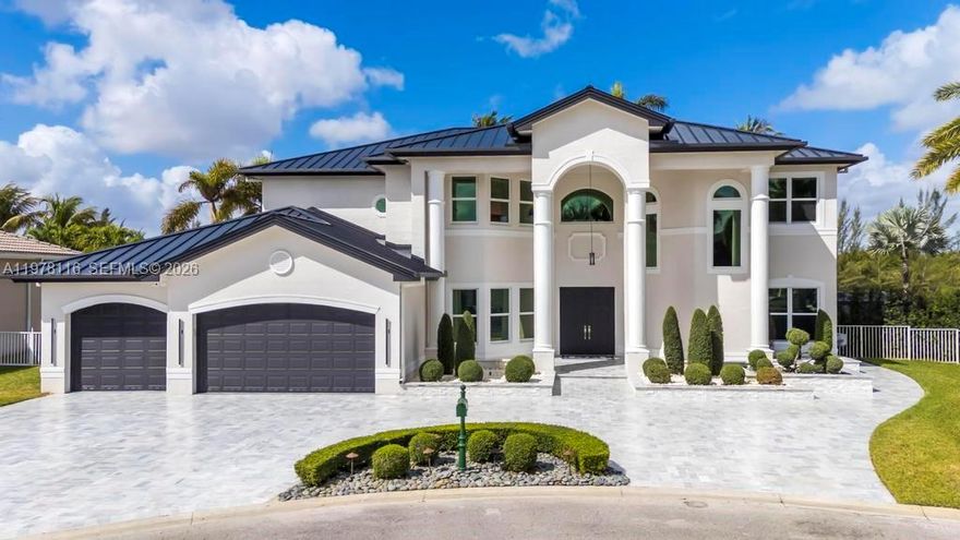 Fully remodeled Sonoma model from top to bottom, this extraordinary residence shows like a designer model home and offers an elevated living experience. High-end finishes and timeless design, including a brand new metal roof, newer AC systems, hurricane impact windows and doors, & a full-house generator for comfort and peace of mind.  Oversized circular driveway finished with marble pavers, set on an expansive lot with fresh exterior paint and beautiful curb appeal. Step inside to a bright interior featuring brand new flooring throughout, soaring ceilings, and an abundance of natural light. Custom designer window drapes and treatments add a refined touch, complemented by modern lighting fixtures and fresh interior paint. The chef’s kitchen is a true showpiece, featuring luxurious marble countertops, top-of-the-line appliances, custom cabinetry, and an open layout overlooking the main living areas perfect for entertaining. Upstairs, a bright sitting area welcomes you with natural light, while the oversized primary suite offers a private balcony with beautiful pool and tranquil lake views. Additional guest bedrooms are generously sized and share an updated Jack-and-Jill bathroom. The garage features a custom golf simulator, and the home is fully integrated as a smart home allowing control directly from your phone. Step outside to a peaceful backyard retreat with a sparkling pool, serene lake views, and lush surroundings—creating the perfect setting for relaxing or entertaining.