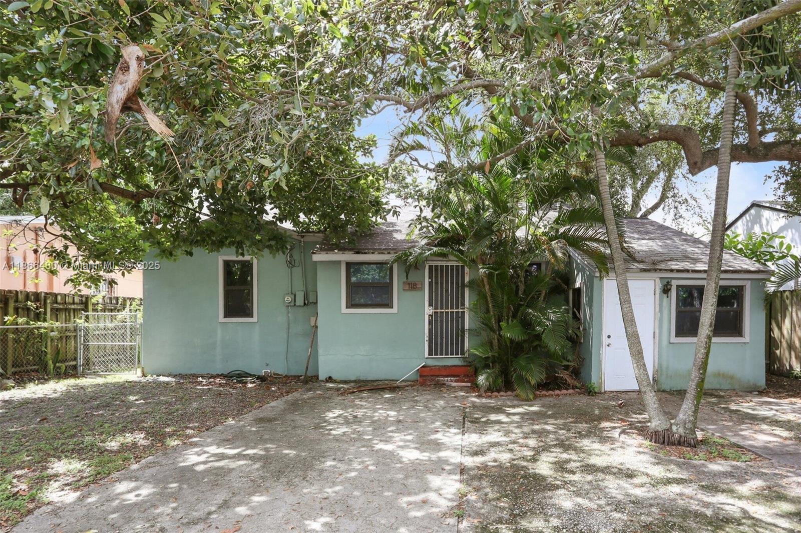 Wonderfully located near the heart of the Design District in the hottest gentrifying neighborhood, this cozy home is only a short drive to Wynwood, Midtown, and Miami Beach. Its prime location offers you convenient urban access while still enjoying the tranquility of a residential neighborhood.
The house includes an attached studio efficiency with a separate entrance. A covered land play, rent this house to a tenant while designing and permitting your dream home. Along with mango, avocado, and other shade trees, there is parking space for up to 3 cars. The back yard is large enough for a future pool.