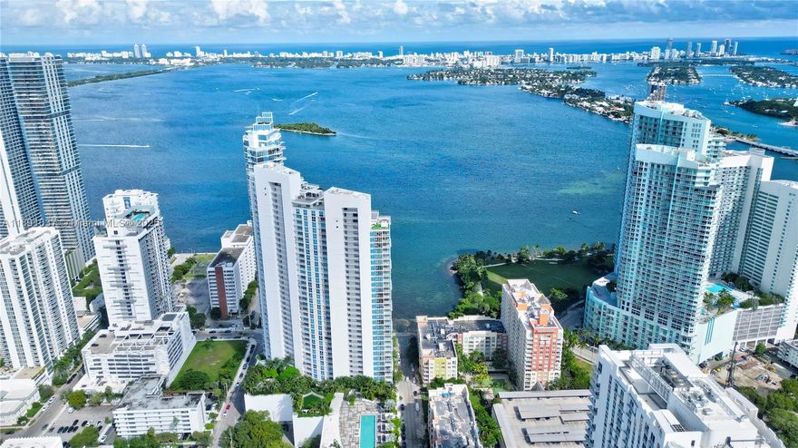 Available for short term rental.  Experience luxurious waterfront living at Paramount Bay with panoramic water views. This direct-bay condo offers a private elevator, sleek 24x24 tiles, custom wooden doors, and a renovated kitchen and baths with California Closets. It comes partially furnished with new TVs and stylish furniture, and is available today for either short-term or long-term stays. Enjoy resort-style amenities: sunrise and sunset pools, deluxe club rooms, business center, and lounge with large TV and kitchen, plus more. Flexible layout can live as a one bedroom plus office/den or function as a true two bedroom.  And the views... There's no better way to start your day with these views!