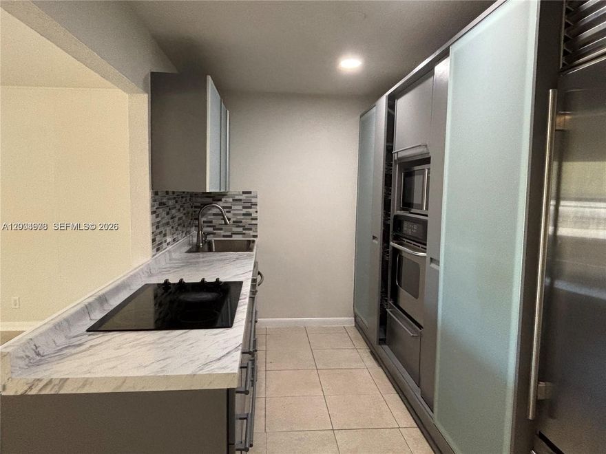 Beautifully renovated 2BR/2BA with tile floors throughout, luxury Italian Kitchen cabinets, SubZero extra large refrigerator, wall oven, glass cooktop, dishwasher and microwave. New washer/dryer combo, contemporary bathroom vanities and lights. Huge master bedroom with plenty of closet space. Impact windows and slidind door. Fenced backyard.  Water and electricity is included in the rent. No HOA Approval.