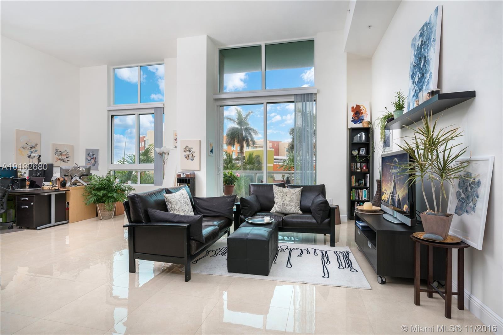 Beautiful 1 bedroom plus den Loft condo with 13.5 FT ceilings at Quantum on the Bay in Edgewater Miami. This light and bright loft has been tastefully upgraded with 24X24 porcelain tile, features 1.5 bedrooms and has parking space on the same floor as the condo. Building features sunrise and sunset pool, 2 story fitness center, theater, club room with billiard tables, 24 hour concierge, and more. Walking distance to Publix, restaurants and more. .