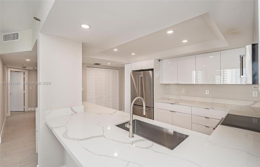 Tastefully redesigned 2-bedroom, 2-bath residence in the exclusive island community of Brickell Key. Spanning over 1,400 SF, this sophisticated home has been thoughtfully renovated with modern finishes, featuring a sleek open-concept kitchen, custom cabinetry, quartz countertops, wood-look porcelain flooring, and a bright contemporary design throughout. Floor-to-ceiling windows fill the residence with natural light and showcase stunning skyline views. Spacious split floor plan offers both comfort and privacy. Enjoy the exclusivity, security, and tranquility of Brickell Key while being moments from Brickell’s premier dining, shopping, and entertainment. Resort-style amenities include 24-hour guard gate, concierge, pool, fitness center, tennis courts, and covered parking.