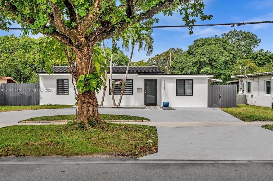 Remodeled 4-bedroom, 3-full-bath modern home, where luxury, functionality, and design come together in perfect harmony. With a stunning chef’s kitchen featuring sleek white quartz countertops, custom two-tone cabinetry in warm wood and high-gloss white, and state-of-the-art appliances, including a statement-making matte refrigerator. A spacious island with seating invites casual meals and conversation, while the clean lines and minimalist hardware add a distinctly contemporary touch. The open-concept living area is bathed in natural light, seamlessly blending indoor comfort with outdoor serenity through large all-glass Impact windows and sliding doors that lead to a private all-fenced backyard oasis. Schedule your showing today!