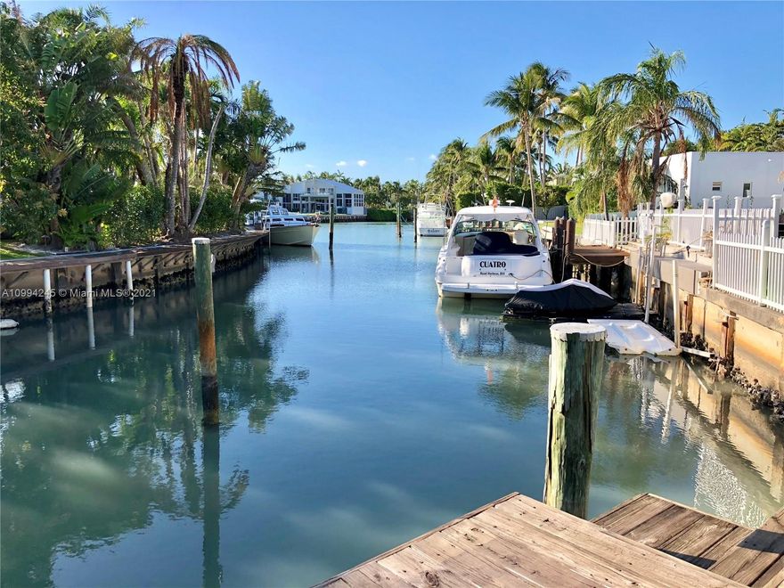 This home is located in a uniquely private corner lot at Island Drive and Cape Florida with 19,042 SF as per survey,  with a water frontage of 77 feet to accommodate comfortably a boat. Boaters paradise with absolute privacy. This home features marble floors throughout, remodeled kitchen and plenty of space with over 5100 SF under A/C, 5 Beds, 5 Baths.  See SURVEY attached for measurements (Second Survey available as well).