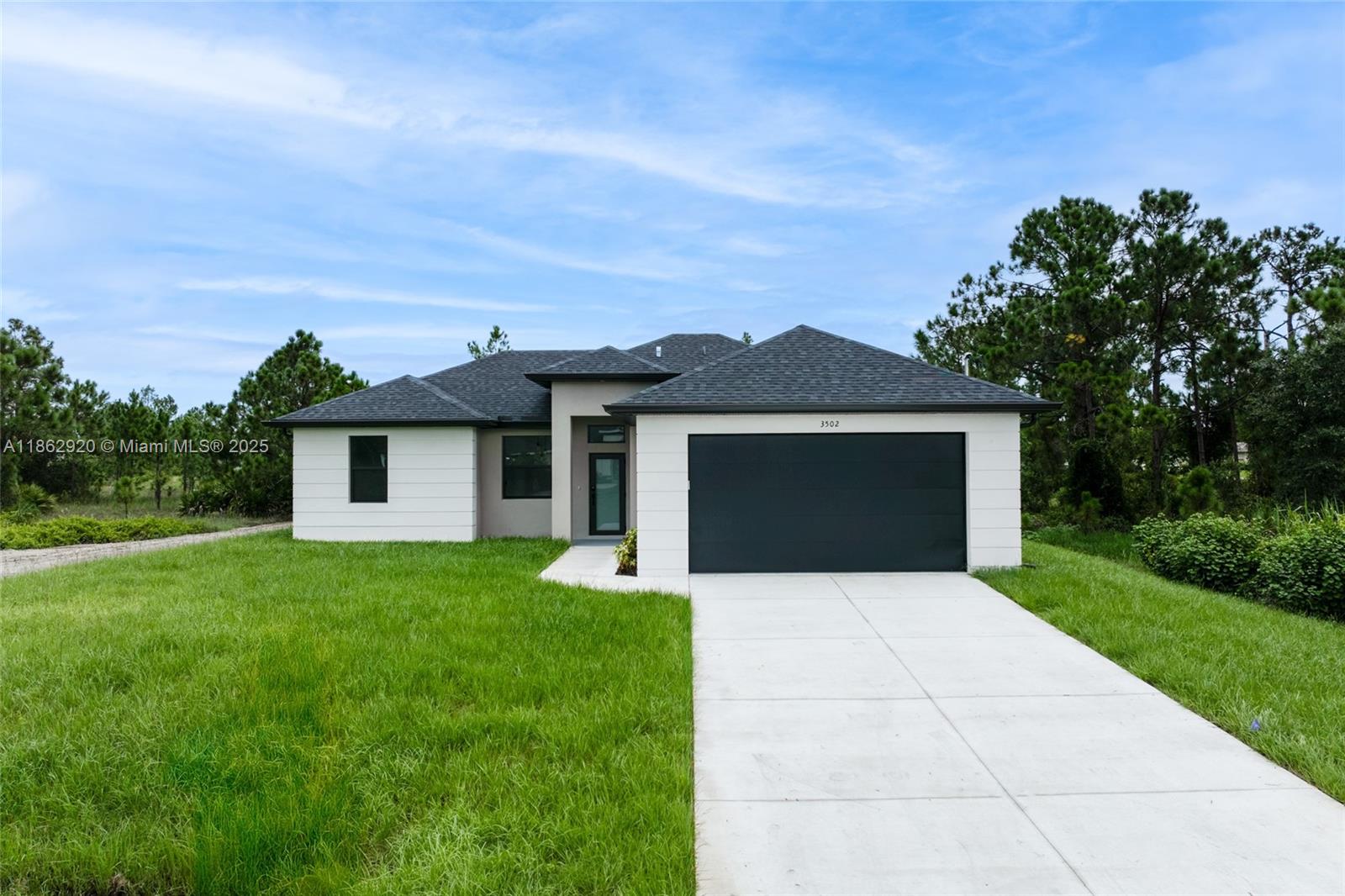 Discover this contemporary new construction home featuring 3 bedrooms and 2 bathrooms, perfectly situated on a desirable lot in Lehigh Acres, Florida. This stunning residence offers spacious living with an open floor plan, an in-house laundry room and an abundance of natural light.
Step inside to elegant porcelain flooring throughout, a sleek modern kitchen with quartz countertops, stainless steel appliances, contemporary cabinets, and fixtures. The impressive waterfall-edge island is perfect for both cooking and entertaining.
Outside, enjoy a large driveway and walkway. Conveniently located near shopping, restaurants, and essential services, this home combines contemporary design with everyday practicality.
Call today to schedule your private showing.