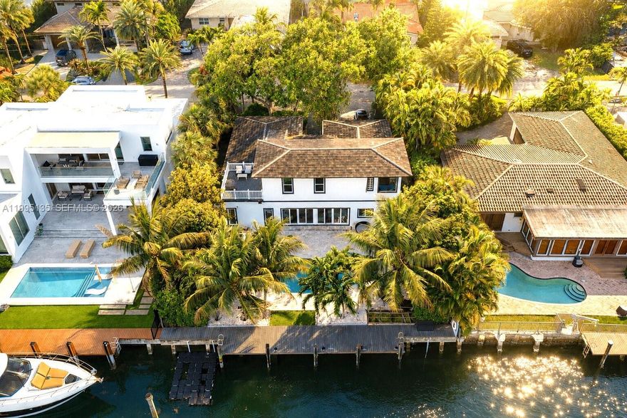 Nestled in the prestigious guard-gated community of Sans Souci Estates, this modern and two-story waterfront residence offers direct ocean access with no fixed bridges, an exceptional opportunity for boating enthusiasts.

This elegant home features 5 bedrooms and 4 bathrooms, including two spacious primary suites thoughtfully positioned on each level for ultimate flexibility and comfort. The interiors are finished with high-end black porcelain plank flooring and a sleek Mia Cucina kitchen, blending modern design with everyday functionality.

Expansive impact windows and doors fill the home with natural light while ensuring peace of mind. Recent upgrades include a 2017 roof, 2019 dock, and a recent sea wall. The 3-zone A/C system, offers efficiency.

Outdoor living is designed for both relaxation and entertaining, with a beautifully landscaped setting, a large natural stone patio, and a saltwater pool overlooking the water, perfect for enjoying Miami’s year-round sunshine. The private dock provides effortless access to the bay and ocean within minutes, ideal for seamless day-to-day boating.

Ideally located just moments from Bal Harbour, beaches, fine dining, and luxury shopping, with convenient access to major highways.

A rare turnkey waterfront property in one of Miami’s most desirable gated communities, offering privacy, security, and the ultimate South Florida lifestyle.