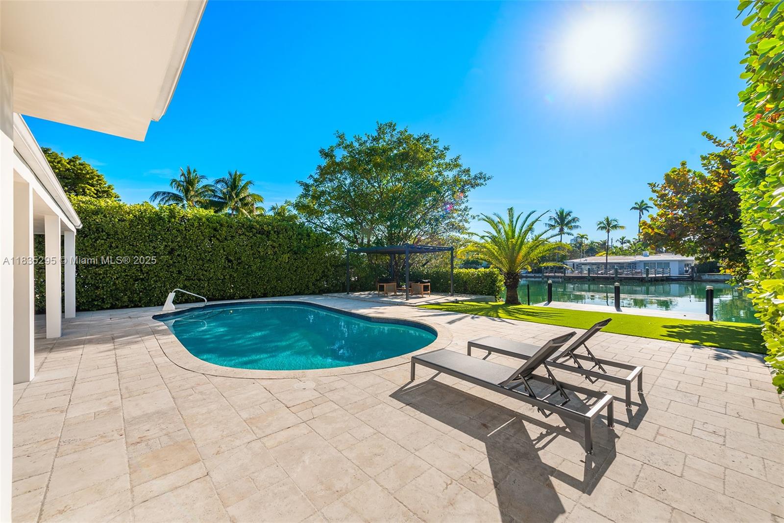 MIMO WATERFRONT GEM w/65 ft on the water, located in the “booming, guard-gated community” of Normandy Shores in North Miami Beach. Bright open layout w/ formal dining, living, and family rooms—ideal for gatherings. With 3,248 SQFT of open interior space & updated designer kitchen w/ cozy breakfast area. Four large and luminous bedrooms with/ 3 fully renovated baths. Impact windows/doors, engineered wood floors, New driveway, 3 A/C zones. Lots of closets. Enjoy water views from your primary suite, living area, private garden, pool, and dock. Great curb appeal w/ 2-car parking. Community w/ NO HOA FEES offers: 18-hole golf w/ driving range, clubhouse dining, tennis and basketball courts, outdoor gym, playground, and more. Close to top-rated schools, the beach, shops, and local restaurants.