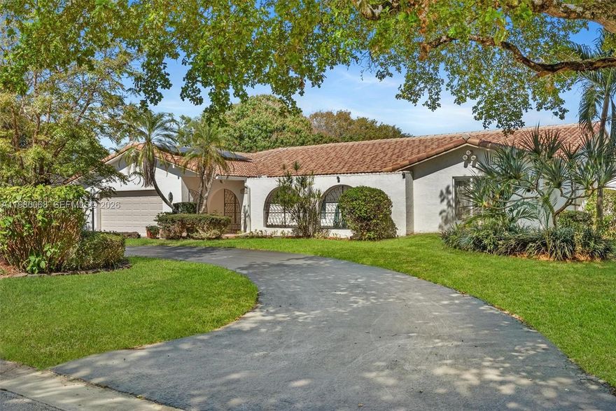 An energy-independent retreat on a quiet dead-end street in the Country Club of Coral Springs, offering private resort-style living with no HOA or mandatory membership. A fully paid 16.77 kWp solar system covers all electricity needs, eliminating power bills, while solar water heating and a private irrigation well further reduce costs. Includes a 220V EV outlet and separate A/C for the primary suite.  Inside, enjoy granite countertops, a center island, Jenn Air grill, and walk-in pantry. Finishes include oversized tile, engineered hardwood, and marble bathrooms. Solar tubes provide natural light, and a central vacuum adds convenience.  The highlight is the expansive 35.9' x 14.8' pool with an energy-efficient pump, perfect for relaxing or entertaining while taking in stunning sunset views over the private golf course. The property also features a fruit orchard with avocado, mango, and banana trees, plus an included electric golf cart.  Additional amenities include clubhouse access, fitness center, pro shop, pickleball courts, and a bar/grill, along with homeowner only walking privileges on the course during off peak times.  A New Tile Roof and full Impact Windows and Doors for your peace of mind. Close to top-tier schools like Parkside Elementary and Coral Glades High, as well as premier shopping nearby. Metal Hurricane shutters and pool safety fencing are in the garage and will stay with the home.