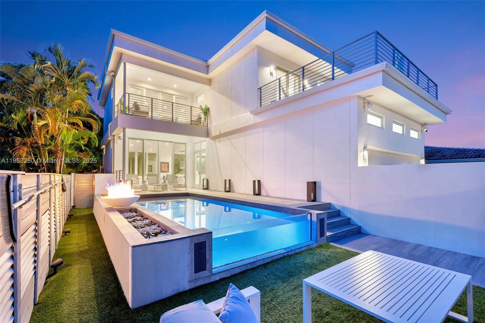 Live in a contemporary, upgraded home with the finest finishes, custom lighting and smart home features. Over $200,000 of upgrades added in the last 2 yrs. 2019 ultra-modern, saltwater filtration pool elevated with a glass wall. Two-stories w/ 3 beds, & 3.5 baths with a 2nd floor upstairs laundry room. Clean lines & open spaces are complemented by elegant finishes, including Panda Marble countertops Wolf and Thermador appliances. 10-foot ceilings enhance the home’s airy, refined ambiance.  Primary suite has a dropdown TV from the ceiling – built-out closets throughout, designed for the best use of space. Serene outdoor spaces feature a sleek covered patio, two 2nd floor balconies, and fully air A/C garage with finished epoxy floors & workstations. Cycle to the Hollywood beach in 10 minutes