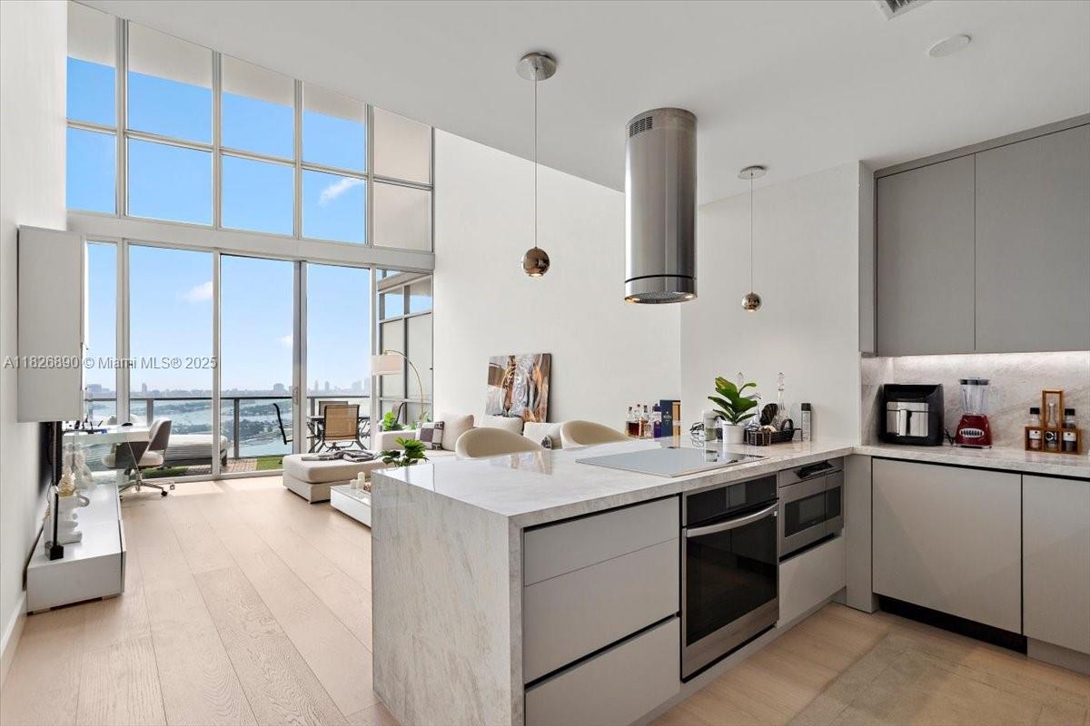 The Ultimate Miami Loft — Perched high on the 43rd floor of Marquis, this one-of-a-kind residence offers unobstructed turquoise water views of Biscayne Bay, the Atlantic Ocean, Miami Beach, and Downtown Miami. Spanning nearly 1,700 SF of fully renovated interior space, this 1-bedroom + DEN features soaring 20' ceilings, floor-to-ceiling windows, an oversized terrace, and abundant storage throughout. No detail was overlooked—brand-new kitchen, bathrooms, flooring, and accent lighting elevate the space. Enjoy 5-star amenities including pools, fitness center and spa, 24-hour security, and exclusive beach club access at the Bentley Hotel in South Beach. Live in the heart of it all—steps from the waterfront park, art and science museums, Arena, Miami Worldcenter, and the future 33-acre park.