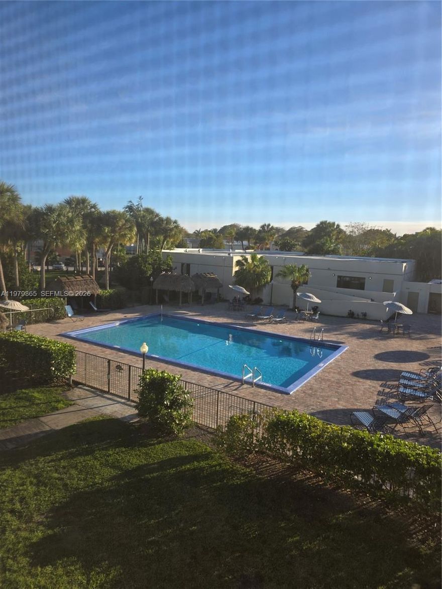 Welcome to this rare top-floor corner unit in Horizons East Condominium featuring one of the BEST views in the community overlooking the main pool and clubhouse. With only one neighboring unit and extra windows, this home is exceptionally bright and private. The living room and primary bedroom feature sliding glass doors leading to a screened balcony with beautiful views and a convenient storage room. Interior highlights include tile flooring throughout, fresh paint, remodeled bathrooms, and a spacious eat-in kitchen with stainless steel appliances. Major upgrades include central A/C replaced in 2021 and updated water heater, plus hurricane accordion shutters for added protection. Move-in ready and filled with natural light, this condo offers comfort, privacy, and resort-style living in a gated Kendall community with great amenities like: (3) pools, (4) tennis courts, 24 hour guard at gate plus a roving guard, remodeled beautiful clubhouse including gym, Lots of Guest Parking, beautiful park across the street from community INDIAN HAMMOCKS PARK, close to expressways, Miami Dade Community College  and FIU University, publix, shops, and much more.