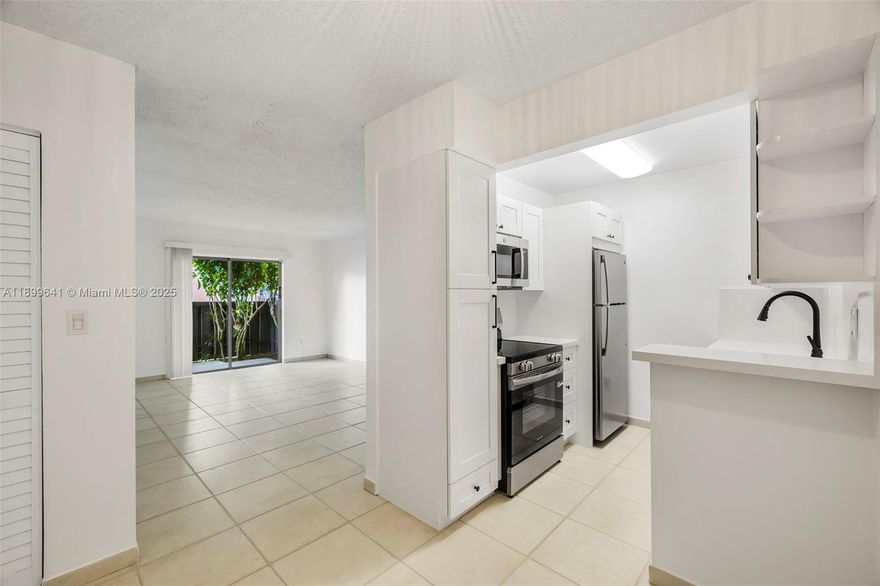 Presenting a fully renovated first floor residence with private patio. It offers a BRAND-NEW KITCHEN, RENOVATED BATHROOM and a spacious bedroom with UPDATED WALK-IN CLOSET. The unit features storm shutters for protection. Its assigned parking space is directly outside the unit. Per Association, NO PETS. Spanish Trace is a strict community that enjoys a secured gated entry, several pools, tennis courts, exercise room and lots of green space. COMMUNITY LAUNDRY (no laundry inside the unit). Publix anchored shopping center with restaurants and shops is directly across the street. Very central East Kendall location! Association has Reserves. No FHA/VA. [Furniture is virtually staged].