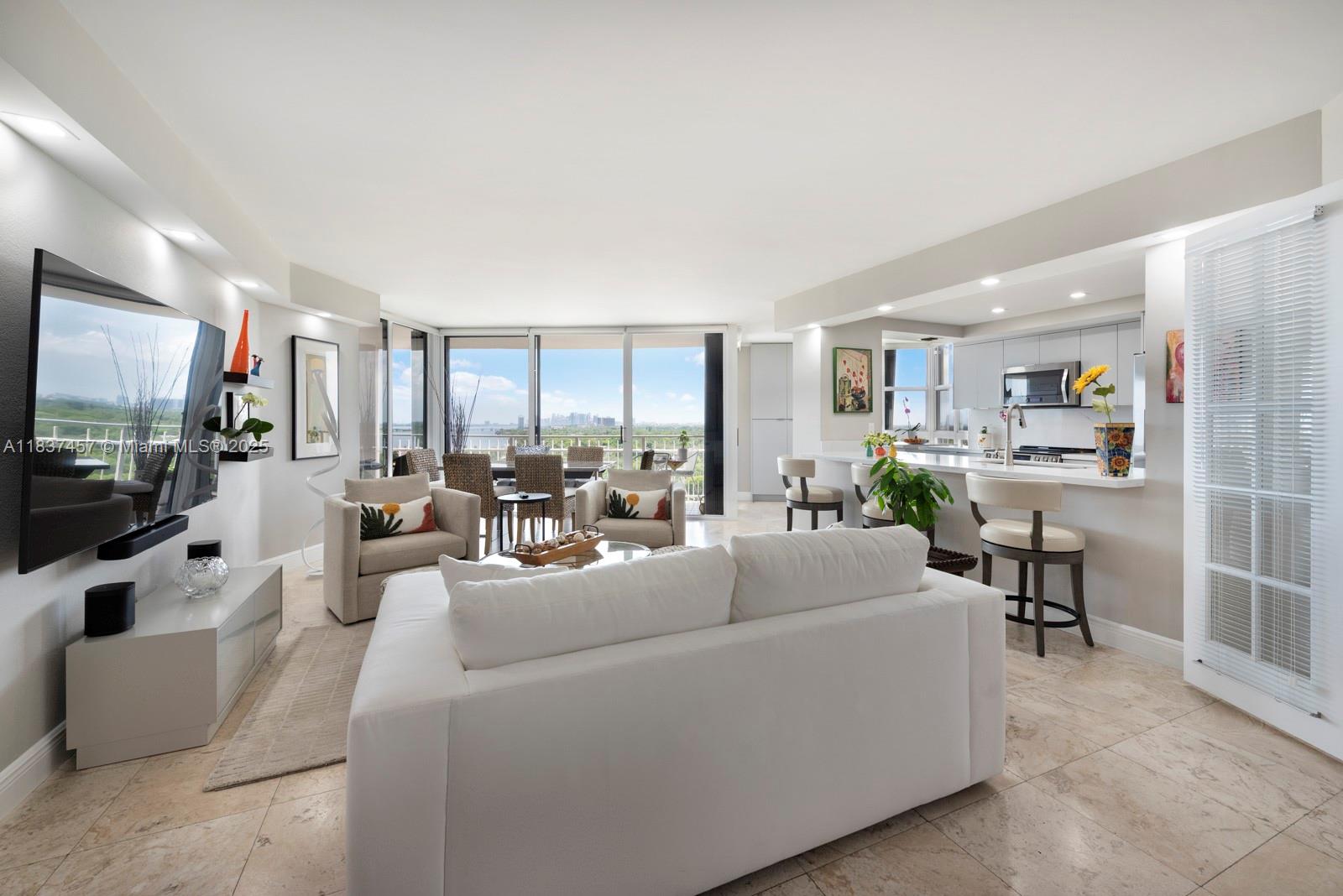 Welcome to a rare opportunity to own in one of Miami’s most beautifully planned bayfront communities, set on 32 lushly landscaped acres just outside Miami Shores. This renovated condo offers sweeping views of Biscayne Bay and downtown Miami, with an open layout, modern kitchen, and a versatile flex space ideal for a home office or studio. Enjoy resort-style living with access to a state-of-the-art spa and gym, hot tub, bayfront pool, and private pools for each of the four distinct communities. Gated with 4-zone security, the property features gardens, walking paths, dog park, playground, two on-site restaurants, vibrant community events, peaceful water features, shaded seating areas, dedicated bike storage, ample guest parking, and 24/7 staffed entry for your peace of mind and comfort.