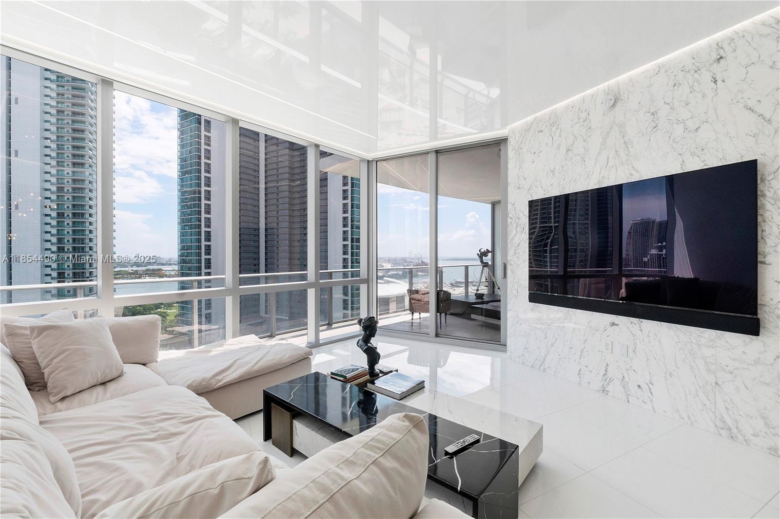 Welcome to the most stunning and custom smart condo 2bed/3bath + den with private foyer in all of Paramount with rare wrap around terrace and direct east water views. This condo is the crown jewel of units at Paramount Miami with no details spared with over $300K in upgrades including: Savant smart home technology to control your lighting, blinds, TV, hidden surround sound speakers & more. Custom kitchen remodel w/ Italian cabinets designed to maximum storage, custom ceiling lighting throughout condo providing incredible ambiance lighting, Calcutta marble accent walls throughout the living room both bedroom, wood paneling, custom closets in the all bedrooms, den and laundry room, upgraded flooring throughout the entire wrap around terrace, electric blinds and more.
