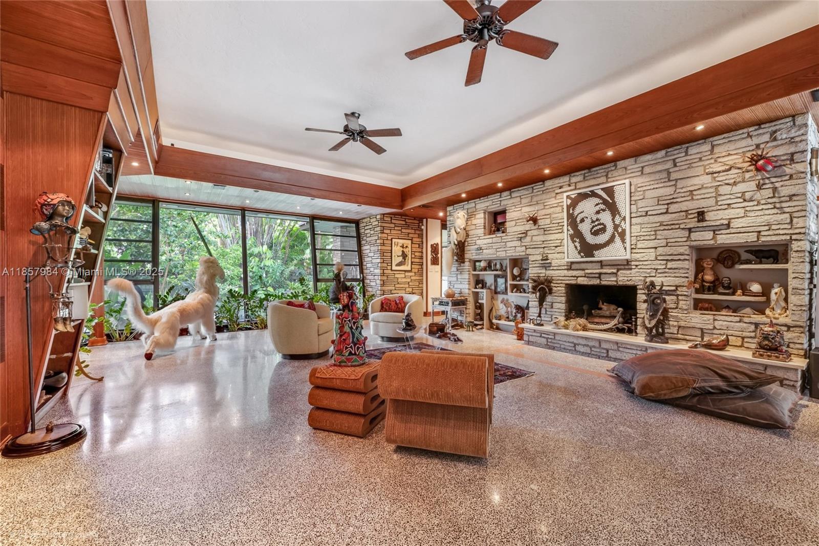 5-acre Mid-Century Modern masterpiece in the Redland, designed by Alfred Browning Parker (protégé of Frank Lloyd Wright). This private, gated sanctuary offers 5,394 SF under A/C between the main home & two cottages, plus 1,499 SF of detached studios & a 410 SF open-air workshop. The main home stuns w/ soaring tongue & groove ceilings, terrazzo floors, walls of glass to the pool, Viking/Sub-Zero/Wolf kitchen, fireplace & hurricane-safe room. A 1,269 SF guest cottage & 667 SF casita generate up to $4K/mo rental income. Grounds rival Fairchild Tropical Garden—orchids, rare bamboos, exotic fruit trees—plus art studio & woodshop. Features: well water, 3-phase power, ag exemption, Tesla-ready electrical. No neighbors for ¼ mile. Seller financing. 2 folios (30-6915-000-0660 & 30-6915-000-0670)