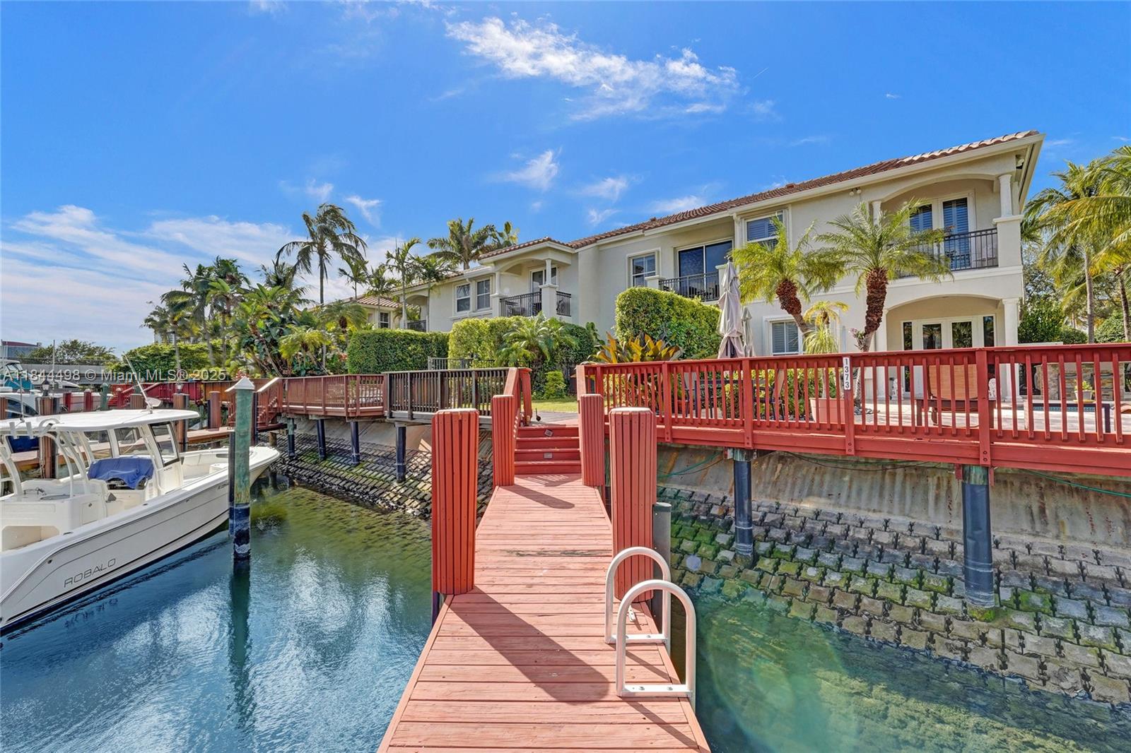 Discover coastal luxury in this beautiful waterfront townhome in the exclusive gated community of Harbor Islands. Designed for the boating enthusiast, enjoy direct ocean access with no fixed bridges and your own private dock—just a 30-minute ride to the Atlantic via Haulover Inlet or Port Everglades. This elegant 3-bedroom, 2.5-bath residence features refined finishes throughout, including 24” marble floors, a custom staircase, and a stunning built-in waterfall. A newly completed waterfront deck and roof (2024), plus a 2025 A/C, add modern comfort to timeless style. With two-car garage, two additional parking spaces, and just steps to the private pool and jacuzzi, this Harbor Islands lifestyle at its finest!