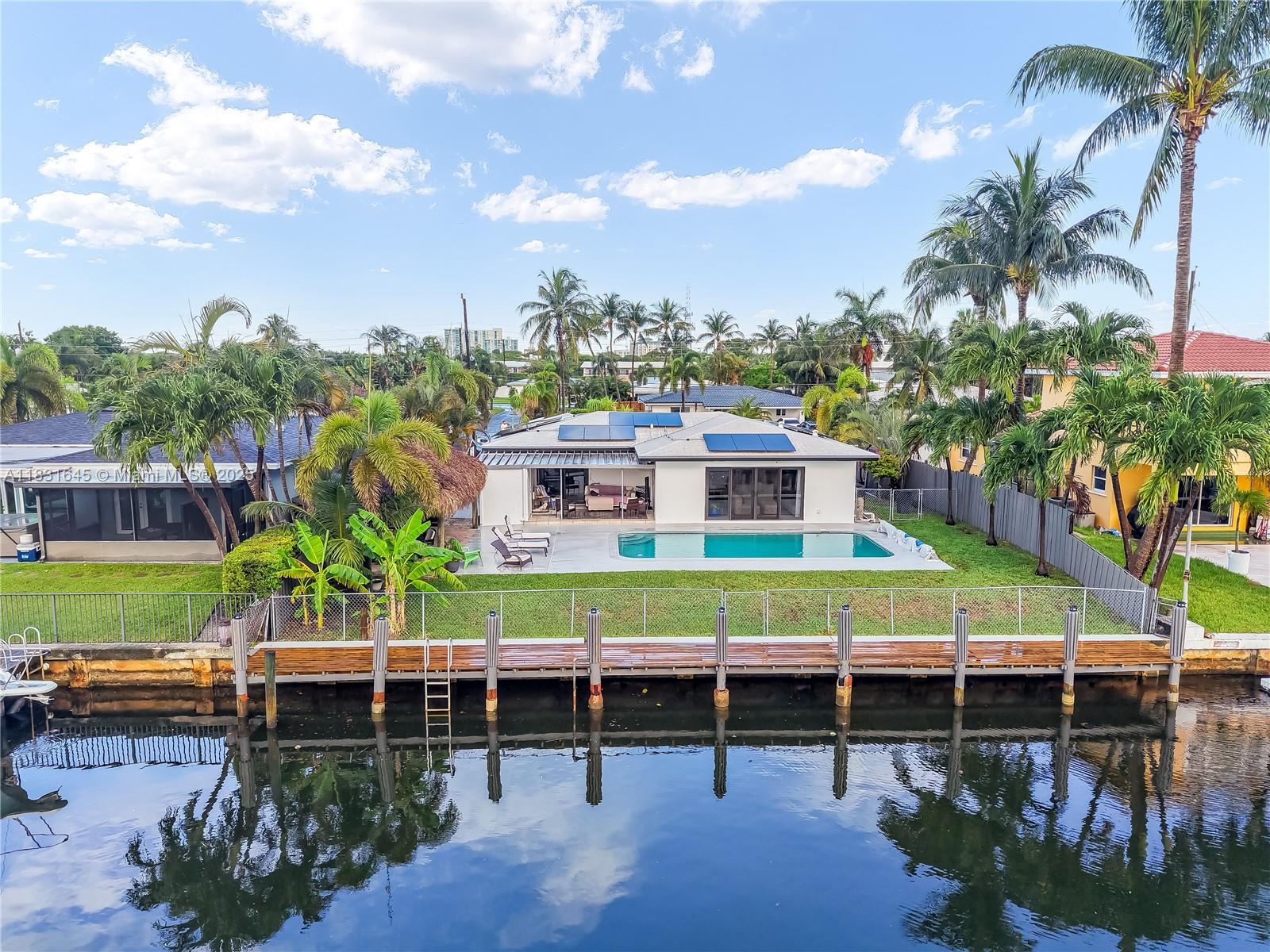 Discover a one-of-a-kind custom home in Garden Isles, where artistic design meets upscale living. This beautifully reimagined residence offers stunning views of a wide, ocean-access canal, creating the perfect backdrop for entertaining or relaxing in style. The home has been extensively remodeled and features impact windows and doors, a 2018 roof and A/C, and a highly reflective sealed roof equipped with 33 fully owned solar panels generating up to 13.6KW of power. Paired with a cutting-edge Tesla Powerwall 3 installed in October 2024, the home offers a complete backup energy solution. A new electrical panel, a tropical tiki hut, and countless thoughtful upgrades make this a rare opportunity. Bring your boat, bring your family, and live the ultimate Florida lifestyle in this amazing home.