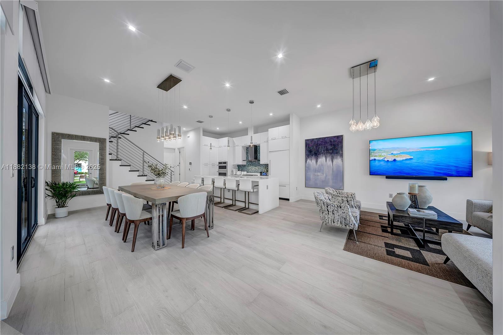 Experience luxury living in the heart of Downtown Doral with this stunning residence featuring 3 spacious bedrooms, each with its own en-suite bathroom, plus an elegant guest powder room. The open-concept living and dining area seamlessly connects to a designer kitchen, complete with top-of-the-line built-in appliances that blend perfectly with the modern cabinetry. Floor-to-ceiling windows with automated blinds fill the home with natural light, highlighting the sleek minimalist finishes throughout. Step outside to a private boutique-style patio, ideal for entertaining or relaxing in style. A rare opportunity to own a contemporary home that combines elegance, comfort, and sophistication in one of Miami’s most sought-after communities.