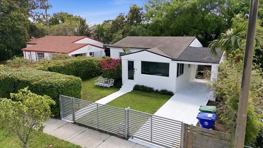 Beautifully updated 2-bedroom, 1-bath home centrally located in Miami. This move-in ready residence features a sleek kitchen with stainless steel appliances, a refreshed bathroom, wood flooring, central AC, and impact windows throughout. A one-car carport offers potential for home expansion. Enjoy a generous backyard perfect for relaxing or entertaining. Conveniently located near schools, parks, shopping, and just minutes from Wynwood, the Design District, Midtown, and Downtown Miami.